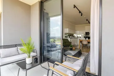 a living room with a couch and a table at Neria at Ellipse Waterfall in Midrand