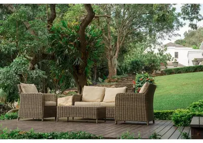 two wicker chairs and a couch on a patio at Sheppard Boutique Hotel in Nelspruit