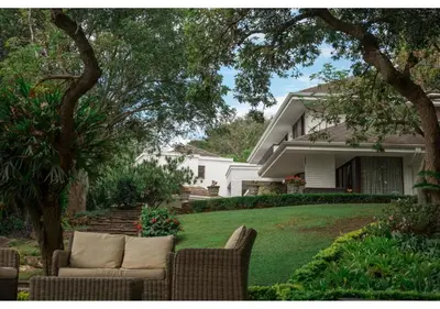 a house with a couch sitting in the yard at Sheppard Boutique Hotel in Nelspruit