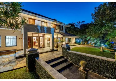 a house with a staircase leading to the front yard at Sheppard Boutique Hotel in Nelspruit