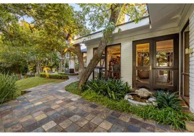 a house with a tree and a walkway at Sheppard Boutique Hotel in Nelspruit
