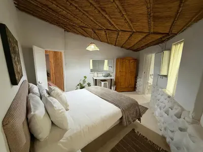a bedroom with a large bed with white pillows at Lemón Villa in Bela-Bela