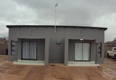a small gray building with two windows on it at Mukutsuri Luxury Apartments in Giyani