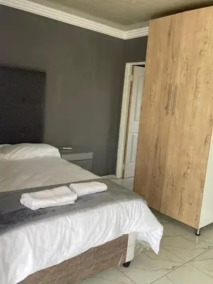 a bedroom with a bed with two towels on it at Mukutsuri Luxury Apartments in Giyani