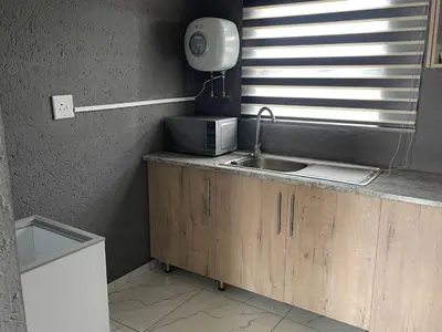 a kitchen with a sink and a microwave at Mukutsuri Luxury Apartments in Giyani
