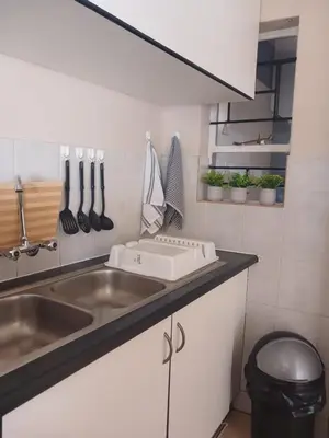 a kitchen with a sink and a counter with utensils at The Menlyn Hideaway in Pretoria