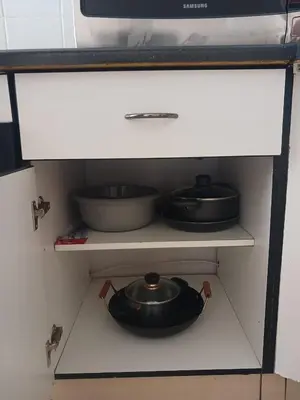 two pots and pans on a shelf in a kitchen at The Menlyn Hideaway in Pretoria