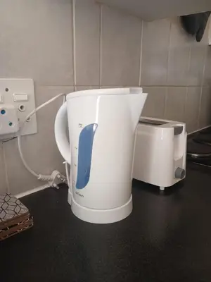 a coffee pot sitting on a counter next to a toaster at The Menlyn Hideaway in Pretoria