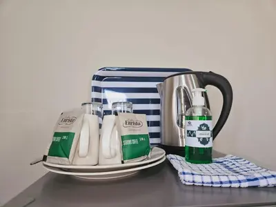 a group of bottles of milk sitting on a counter at North ryde guest lodge southafrica in Kempton Park