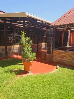 a plant in a pot in the yard of a building at North ryde guest lodge southafrica in Kempton Park