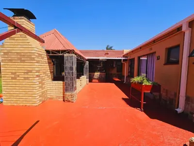 an empty courtyard of a house with a building at North ryde guest lodge southafrica in Kempton Park