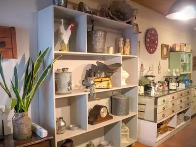 a shelf filled with lots of items in a room at De Kunst Huisje in Bela-Bela