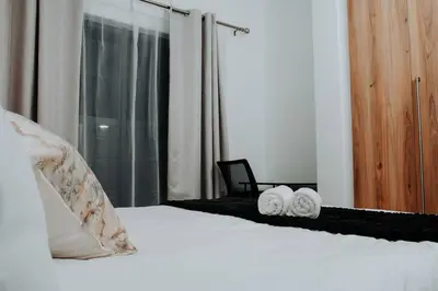 a bedroom with a bed with two towels on it at The Blyde Lagoon Apartment in Pretoria