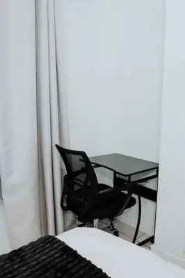 a desk and a chair in front of a window at The Blyde Lagoon Apartment in Pretoria