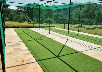 a tennis court with a net on a tennis court at Olifants River Lodge Campsites by Dream Resorts in Botshabelo