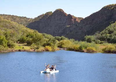a group of people in a boat on a river at Olifants River Lodge Campsites by Dream Resorts in Botshabelo