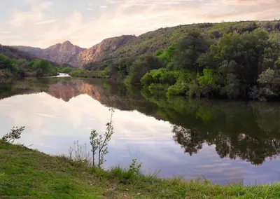 a view of a river with mountains in the background at Olifants River Lodge Campsites by Dream Resorts in Botshabelo
