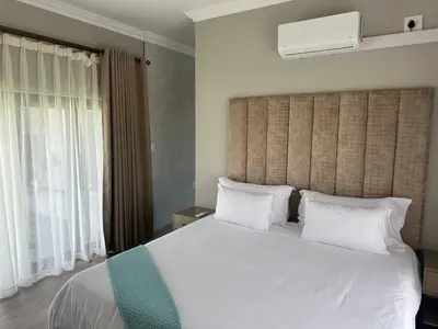 a bedroom with a large bed with white sheets and pillows at CELONIA VILLA Euphoria 442 in Naboomspruit