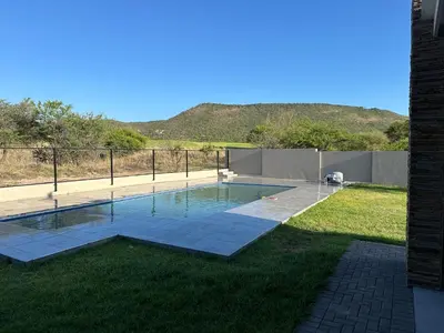 a swimming pool in the middle of a yard at CELONIA VILLA Euphoria 442 in Naboomspruit