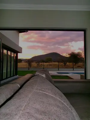 a large window of a building with a view of a mountain at CELONIA VILLA Euphoria 442 in Naboomspruit