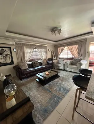 a living room with a couch and a table at 3 Bed home Nelspruit Golden Crescent in Nelspruit