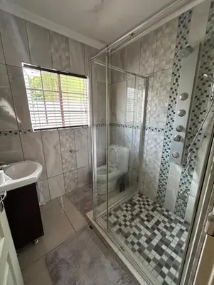 a bathroom with a shower and a toilet and a sink at 3 Bed home Nelspruit Golden Crescent in Nelspruit