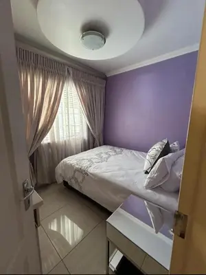 a purple bedroom with a bed and a window at 3 Bed home Nelspruit Golden Crescent in Nelspruit