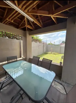 a glass table and chairs on a patio at 3 Bed home Nelspruit Golden Crescent in Nelspruit