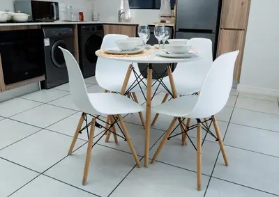 a kitchen with a table and chairs with wine glasses at Affordable Luxury villa at the Blyde in Pretoria