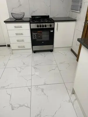 a kitchen with white marble floors and an oven at Palma de Mallorca in Kempton Park