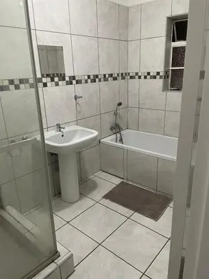 a bathroom with a sink and a tub and a toilet at Palma de Mallorca in Kempton Park