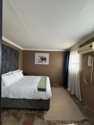 a bedroom with a large bed in a room at Spacious stay-in 2bedroom apartment in Kempton Park