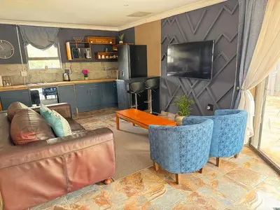 a living room with a couch and a table at Spacious stay-in 2bedroom apartment in Kempton Park