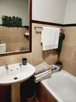 a bathroom with a sink and a bath tub at Blue Button in Pretoria