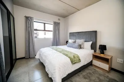 a bedroom with a large bed and a window at K47 propertyzz in Midrand