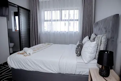 a bedroom with a large white bed with a window at K47 propertyzz in Midrand