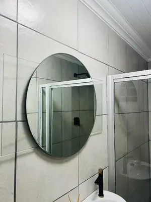 a bathroom with a mirror and a sink at Sunset Hideaway in Pretoria