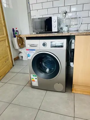 a washing machine sitting under a counter in a kitchen at Sunset Hideaway in Pretoria