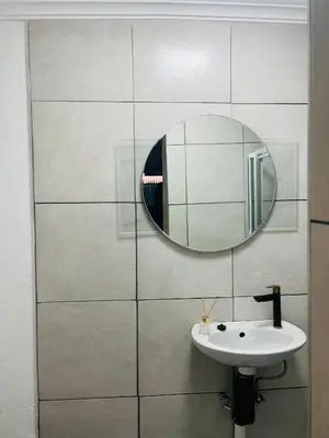 a bathroom with a sink and a mirror at Sunset Hideaway in Pretoria