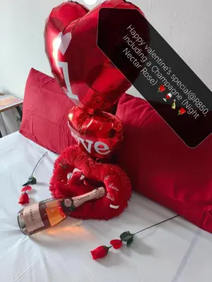 a red teddy bear sitting on top of a bed at Sunset Hideaway in Pretoria