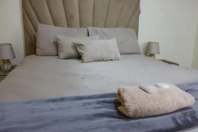 a bed with two pillows and a towel on it at Okuhlekwethu Guesthouse in Witbank