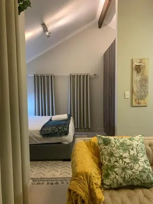 a bedroom with a bed and a couch in it at Smartz Apartment Studio in Midrand