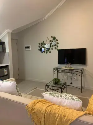 a living room with a couch and a flat screen tv at Smartz Apartment Studio in Midrand