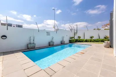 a swimming pool in the backyard of a house at Smartz Apartment Studio in Midrand