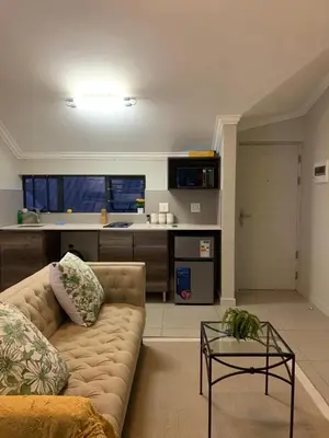 a living room with a couch and a table at Smartz Apartment Studio in Midrand