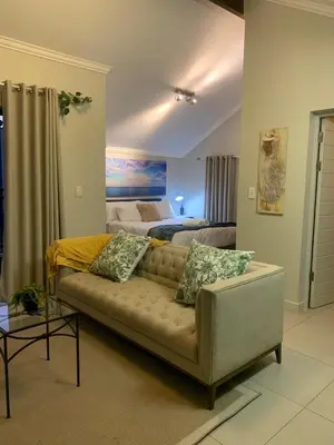 a living room with a couch and a bed at Smartz Apartment Studio in Midrand
