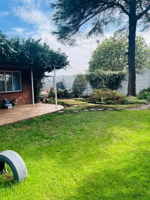a yard with a tire laying in the grass at Sunset Hideaway in Pretoria