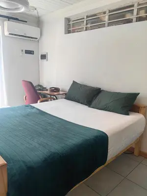 a bedroom with a bed and a table and chairs at Sunset Hideaway in Pretoria