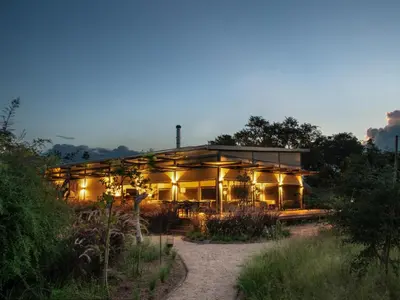a large building with lights in front of it at Amaya in Hoedspruit