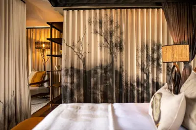 a hotel room with a bed and a curtain at Amaya in Hoedspruit